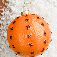 Orange: A glass ornament of a clove spiked orange.