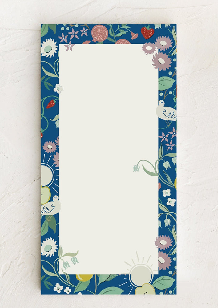 A notepad with blue botanical border.