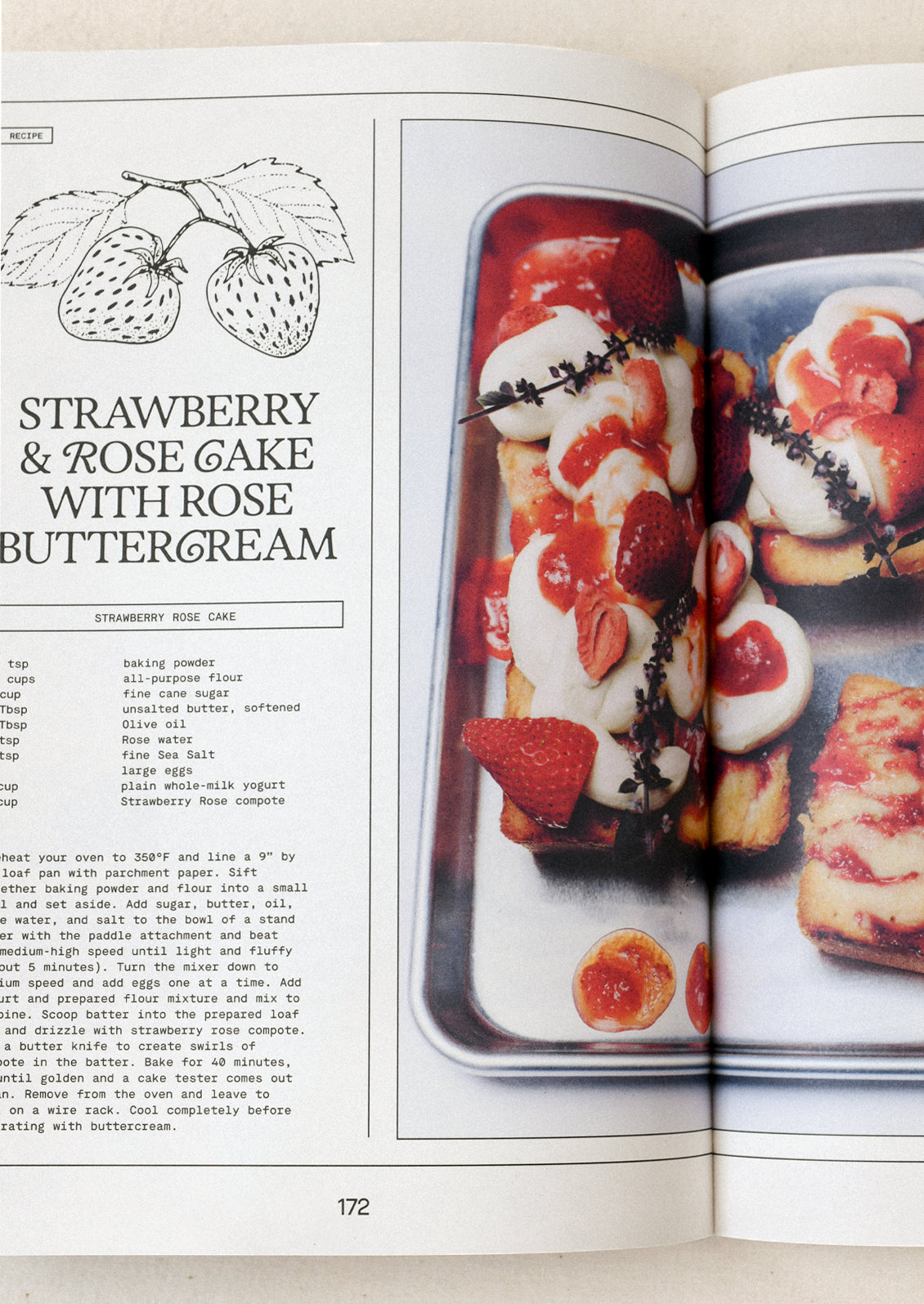 A book open on a table with an image and recipe for strawberry & rose cake with rose buttercream.