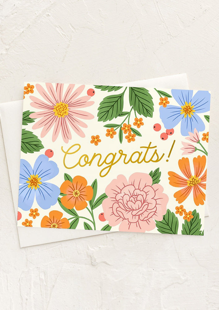 A floral print card reading "Congrats!" in gold script.