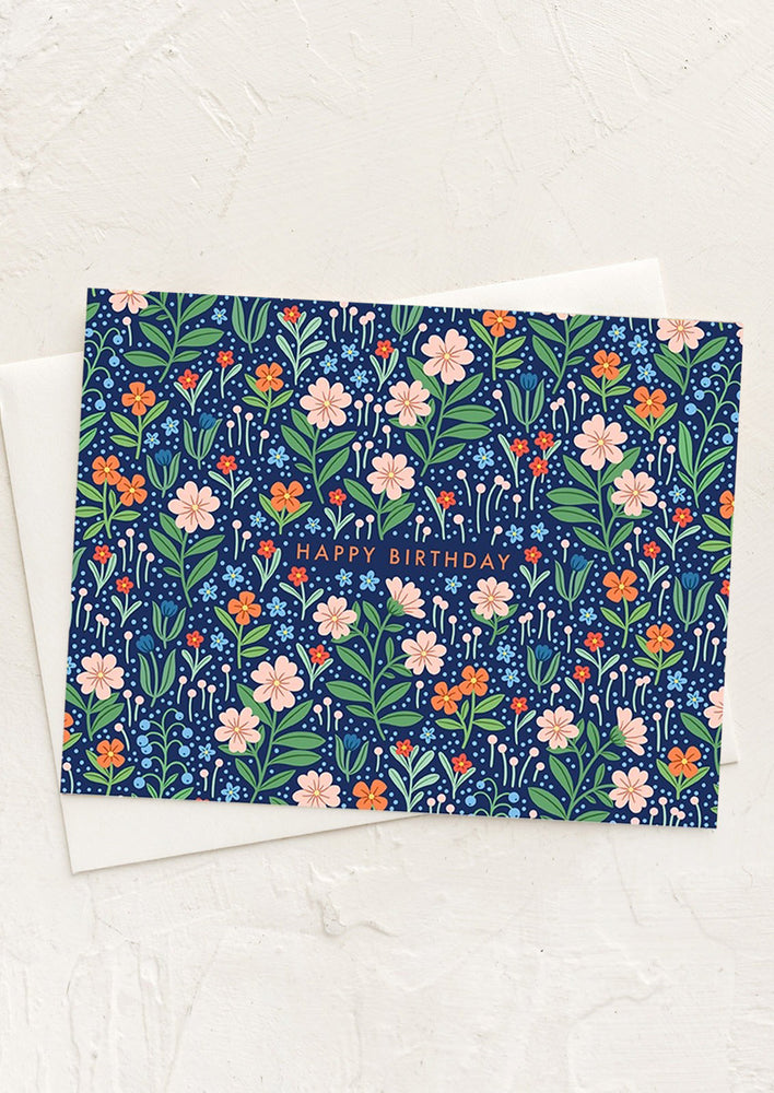A blue and pink floral print card reading "happy birthday" across front.