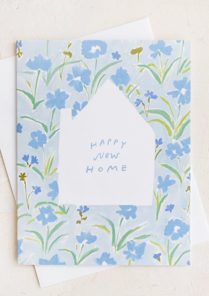 1: A greeting card with house cutout and floral pattern.