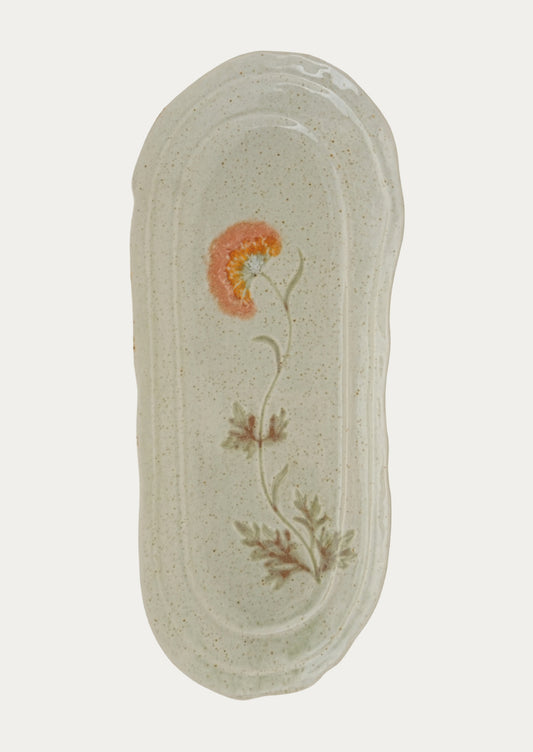 Decorative platter with floral design on a light gray background