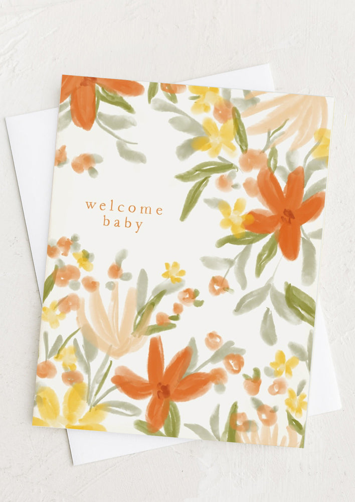 A floral print card reading "Welcome baby".