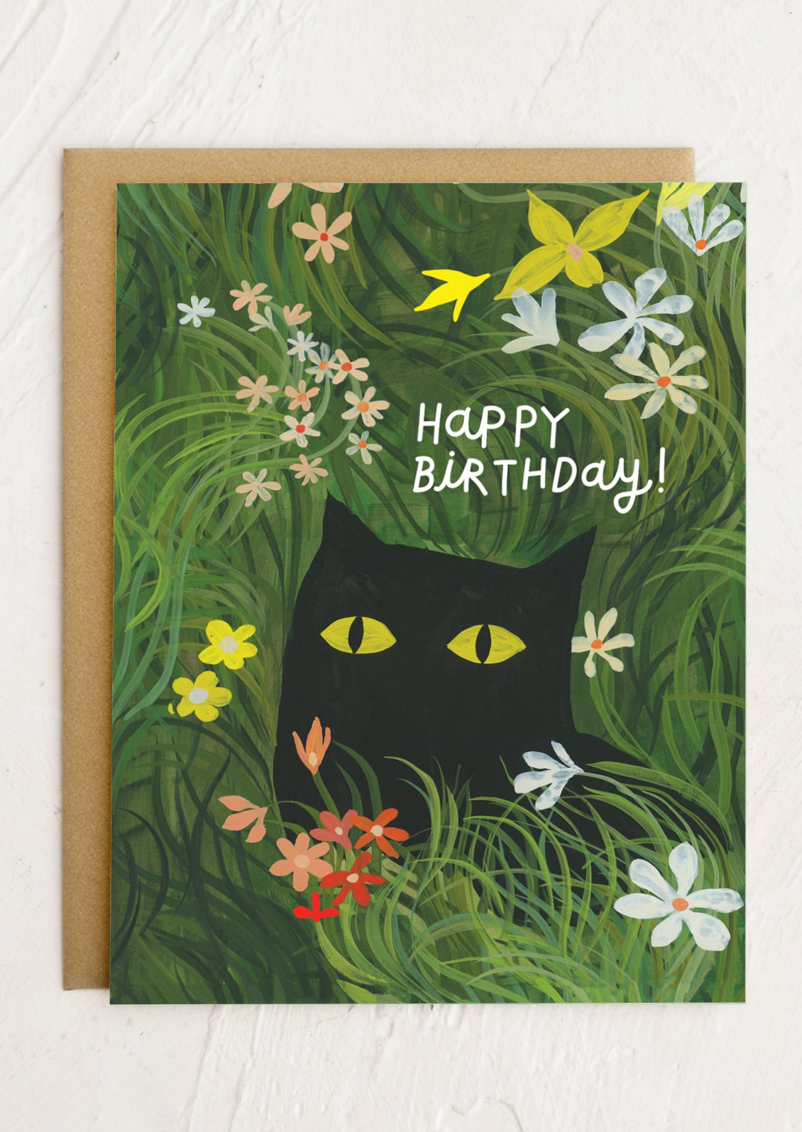 Birthday card with a black cat surrounded by flowers and the text 'Happy Birthday!' on a green background.