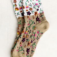 Tan Multi: A pair of two-tone socks in white and tan with multicolor flower pattern.