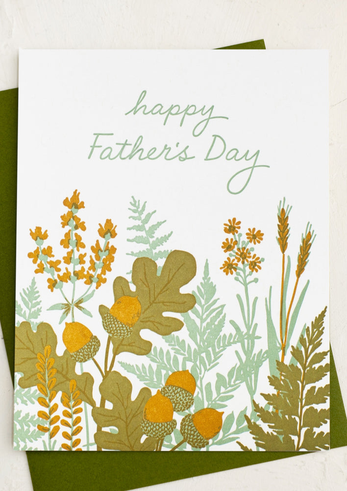 A letter pressed greeting card with foliage pattern reading "Happy Father's Day".