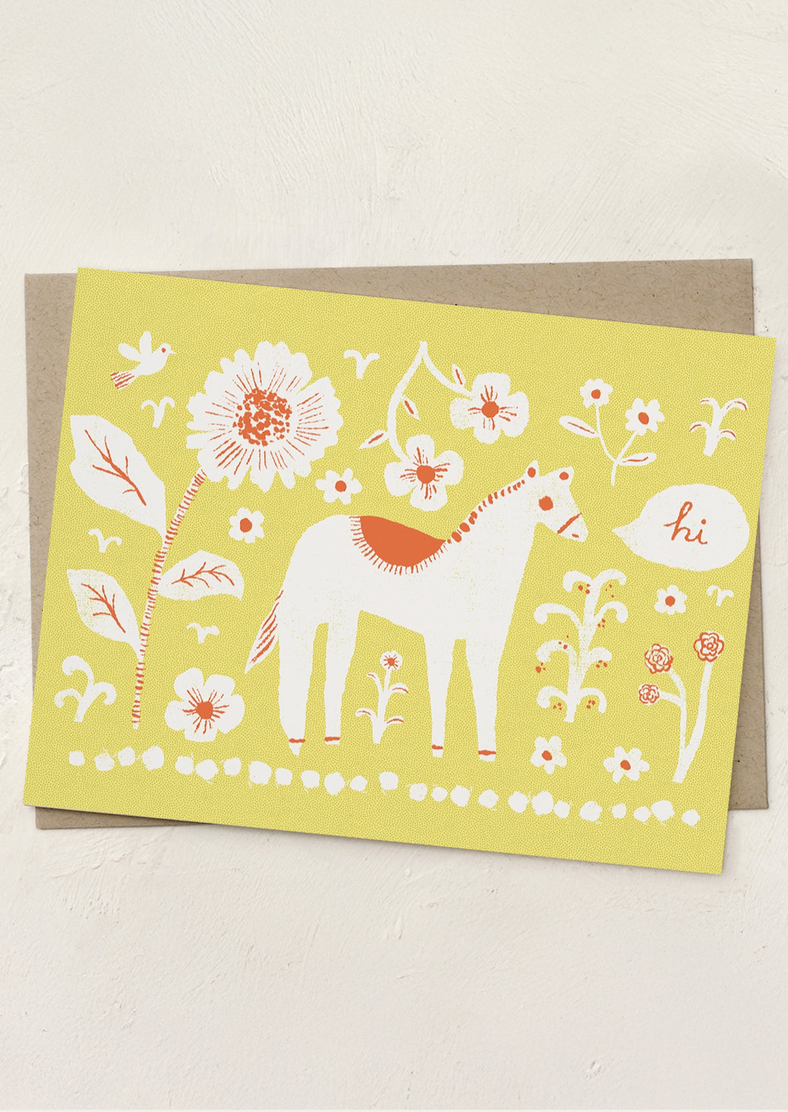 Greeting card with a horse and floral design on a yellow background
