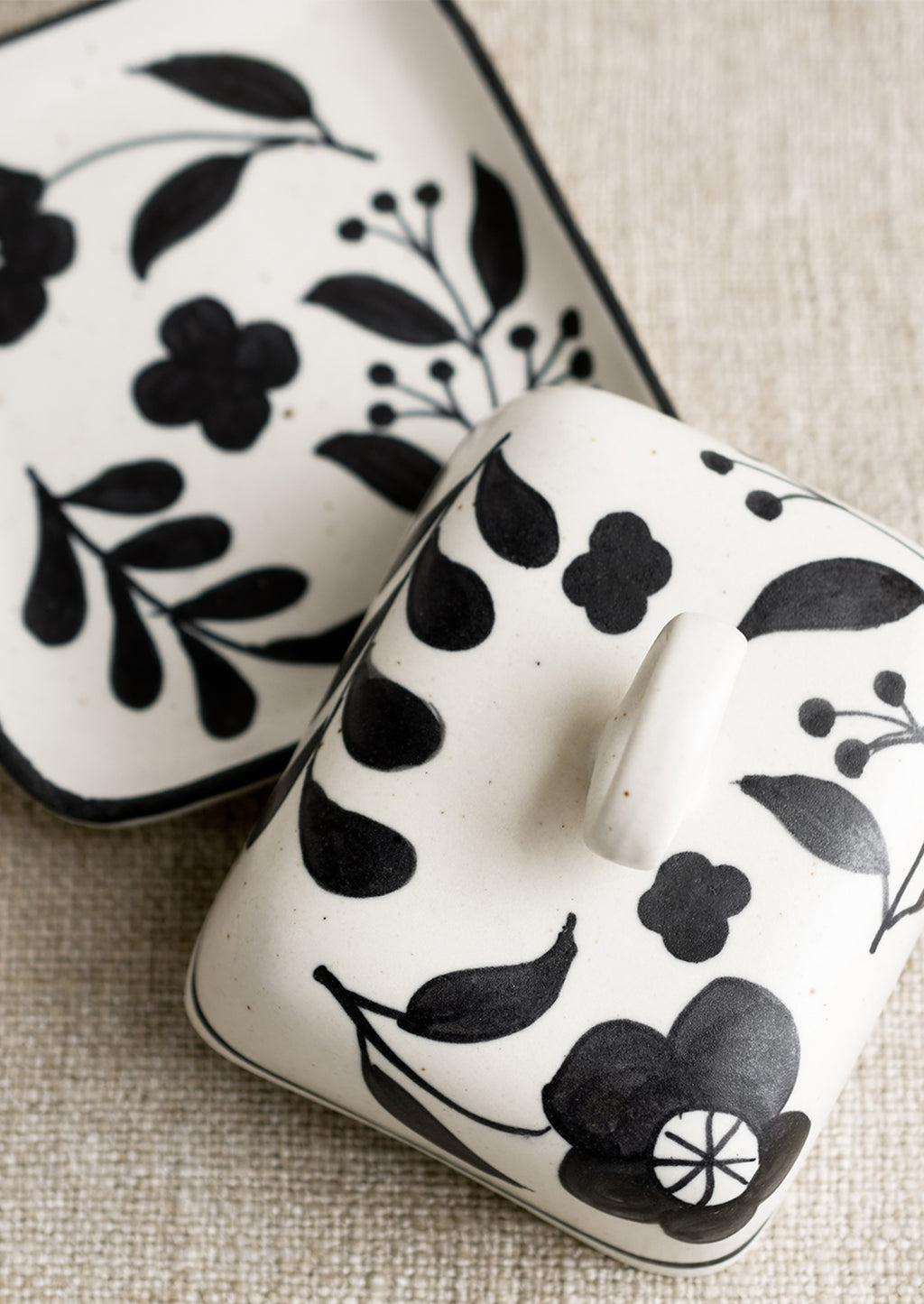 3: A black and white floral print butter dish.