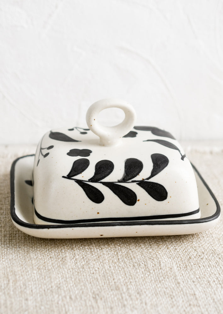 A black and white floral print butter dish.
