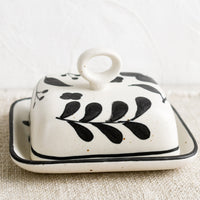 4: A black and white floral print butter dish.