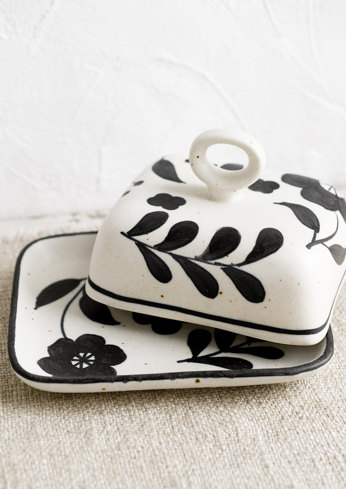 A black and white floral print butter dish.