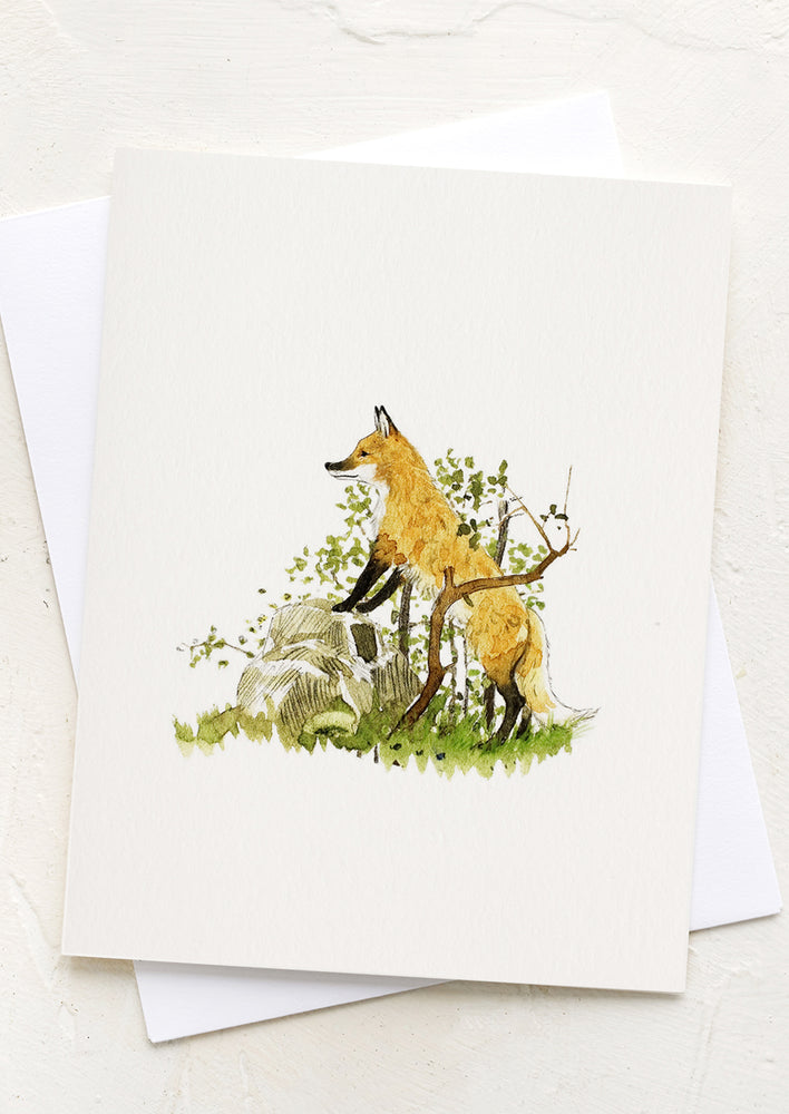 A card with illustration of a fox in the woods.