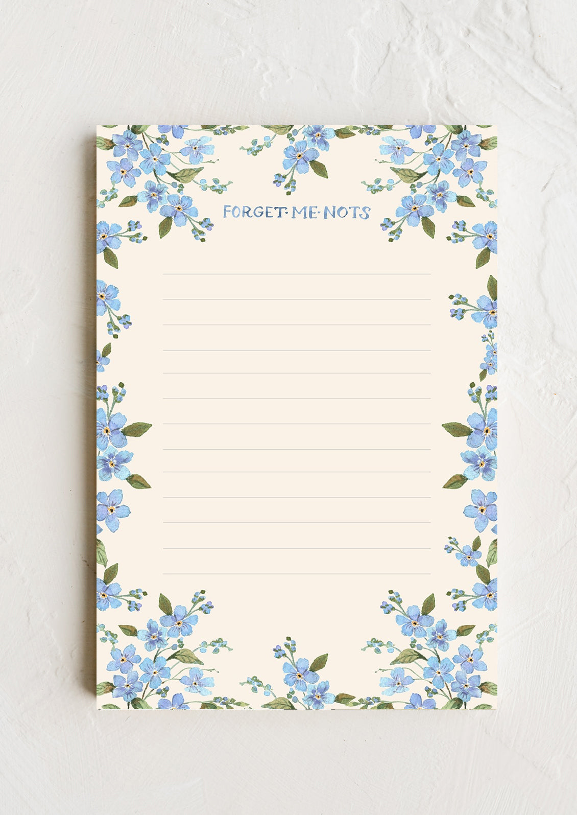 A notepad with forget me not floral border.
