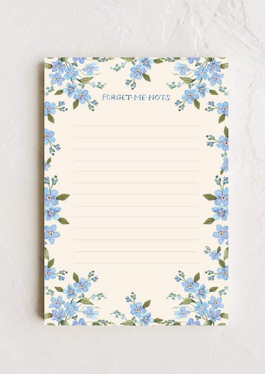 A notepad with forget me not floral border.