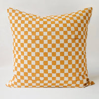2: The reverse side of a square pillow with mustard checker print.