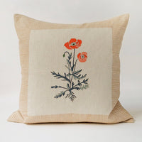 1: A square block printed throw pillow with framed poppy design.