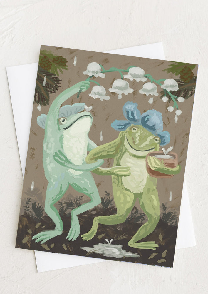 A greeting card with illustration of frogs dancing in the rain.
