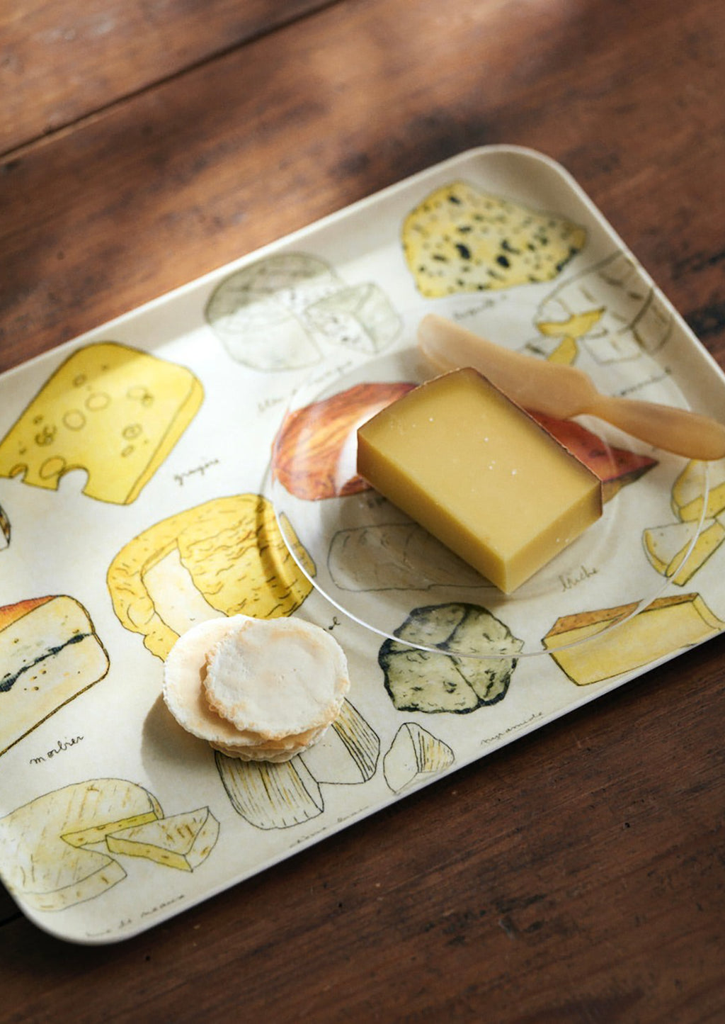 2: A serving tray with cheese print.