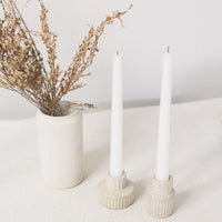 4: Natural fluted taper candle holders on table scene.