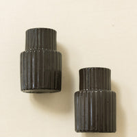 Tall / Charcoal: Black fluted taper candle holders in tall shape.