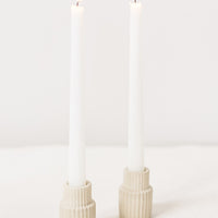 Tall / Natural: Natural fluted taper candle holders on table.