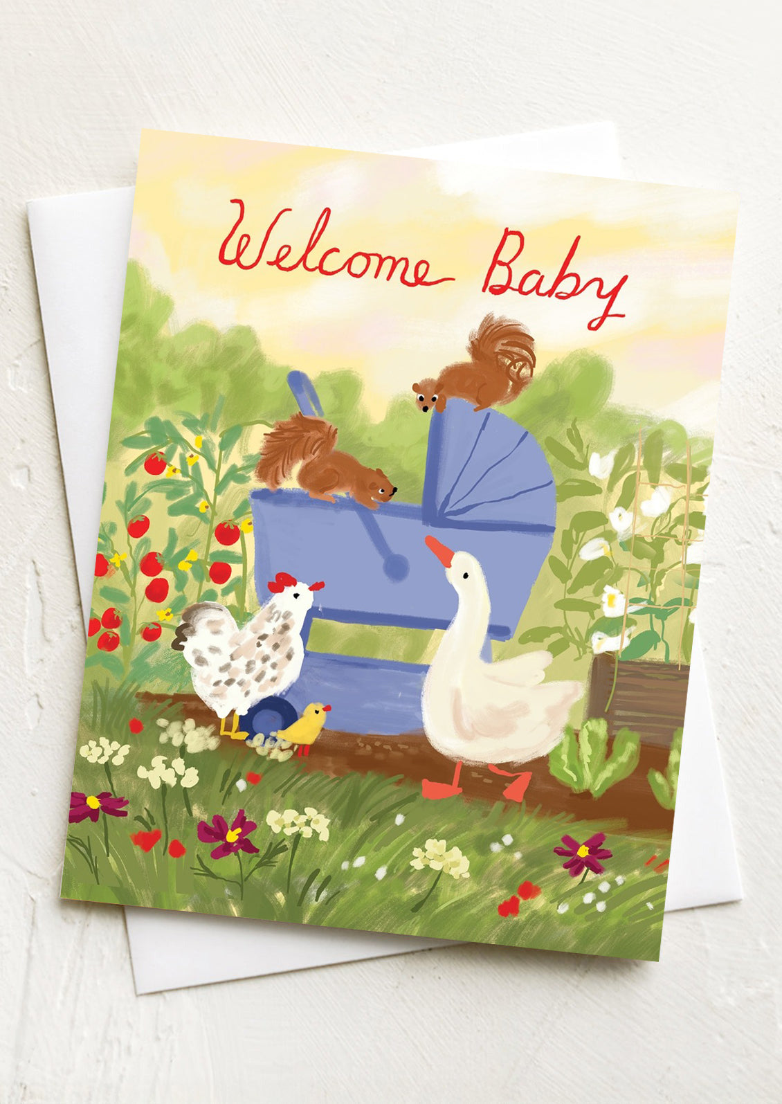A greeting card with illustration of animals in garden, text at top reads "Welcome Baby".