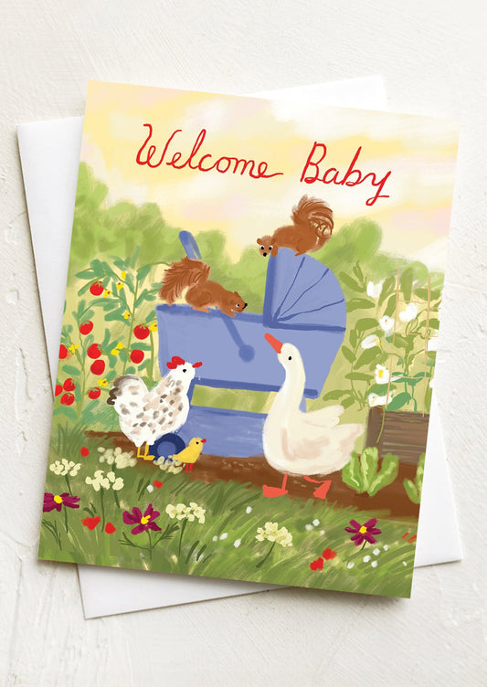 A greeting card with illustration of animals in garden, text at top reads "Welcome Baby".