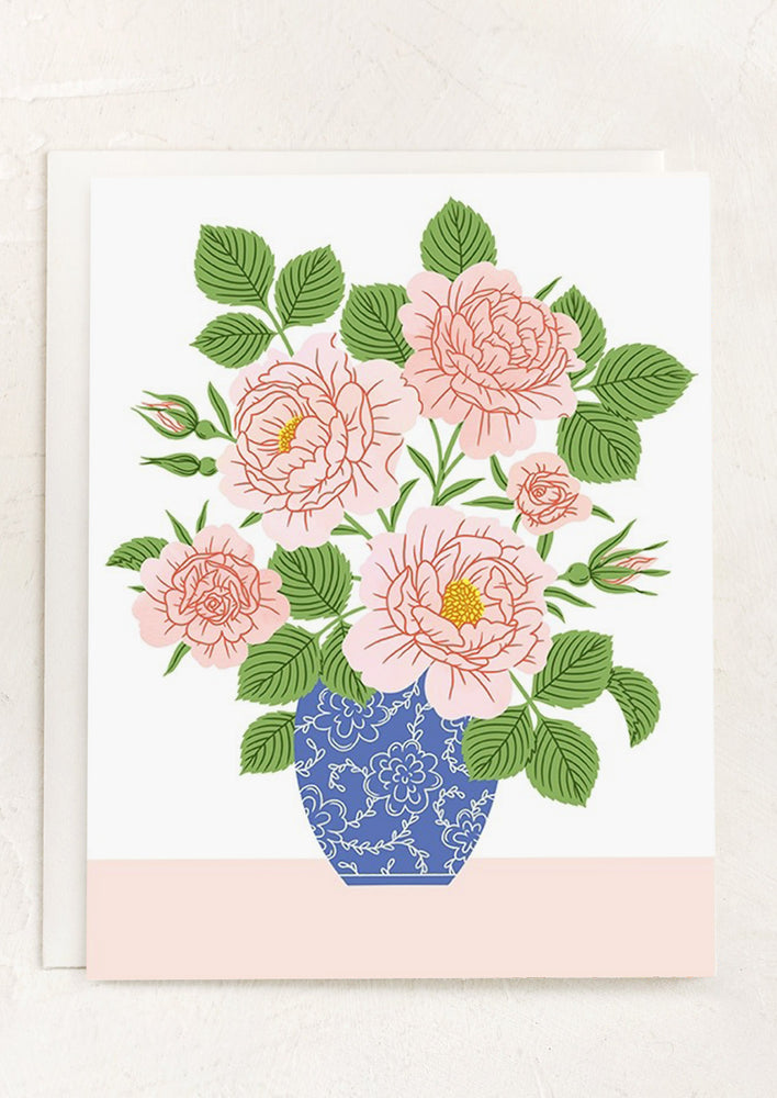 A blue and pink card with floral arrangement image.