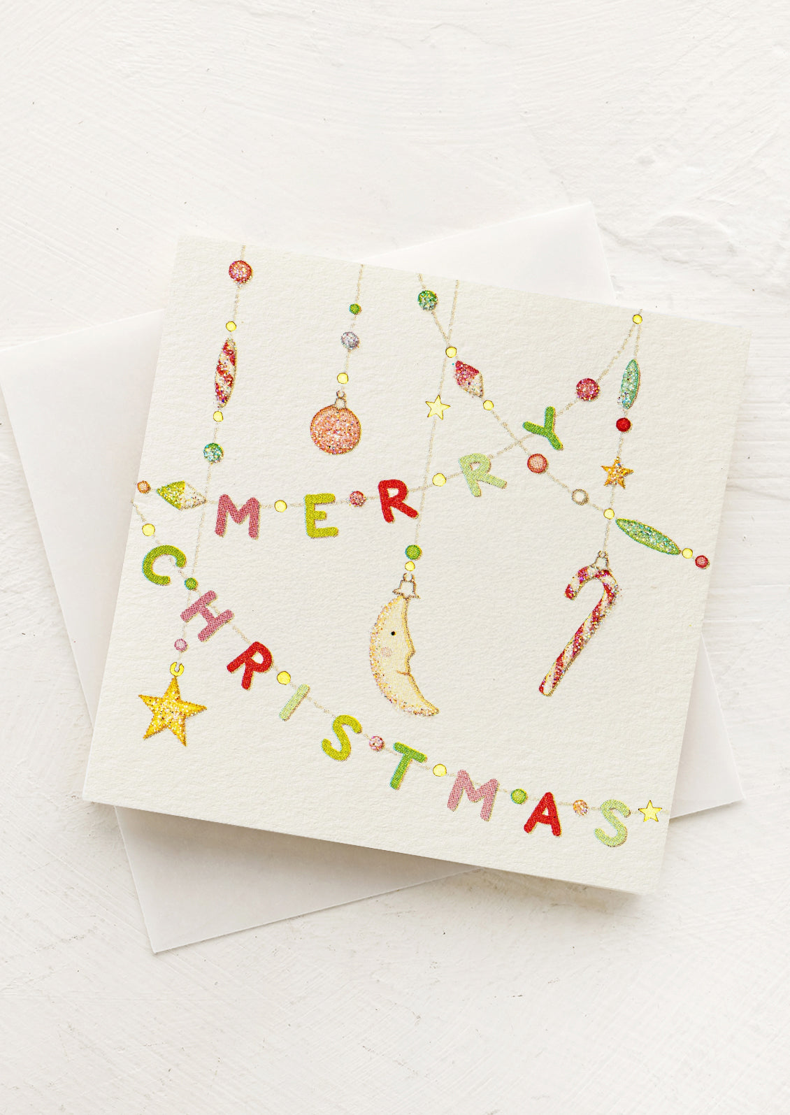 Christmas card with colorful ornaments spelling 'Merry Christmas' on a white background