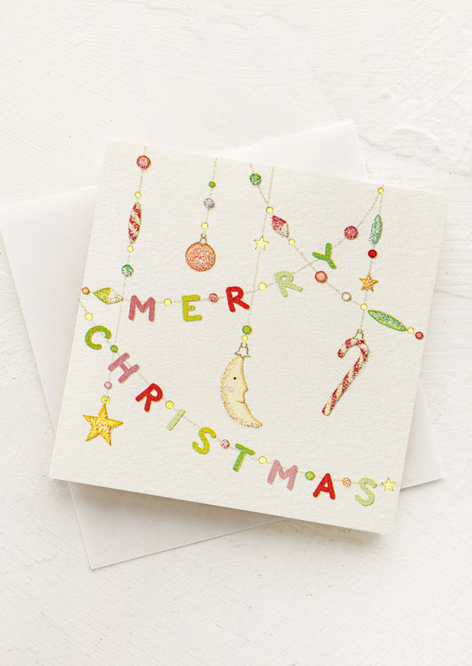 Christmas card with colorful ornaments spelling 'Merry Christmas' on a white background