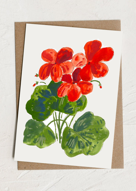 Card with red flowers and green leaves on a white background