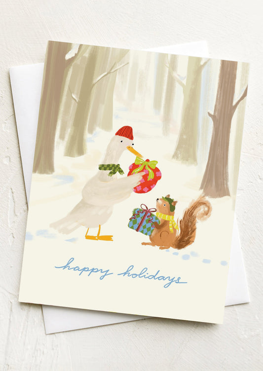 A greeting card with image of a duck and squirrel exchanging gifts, text reads "Happy holidays".