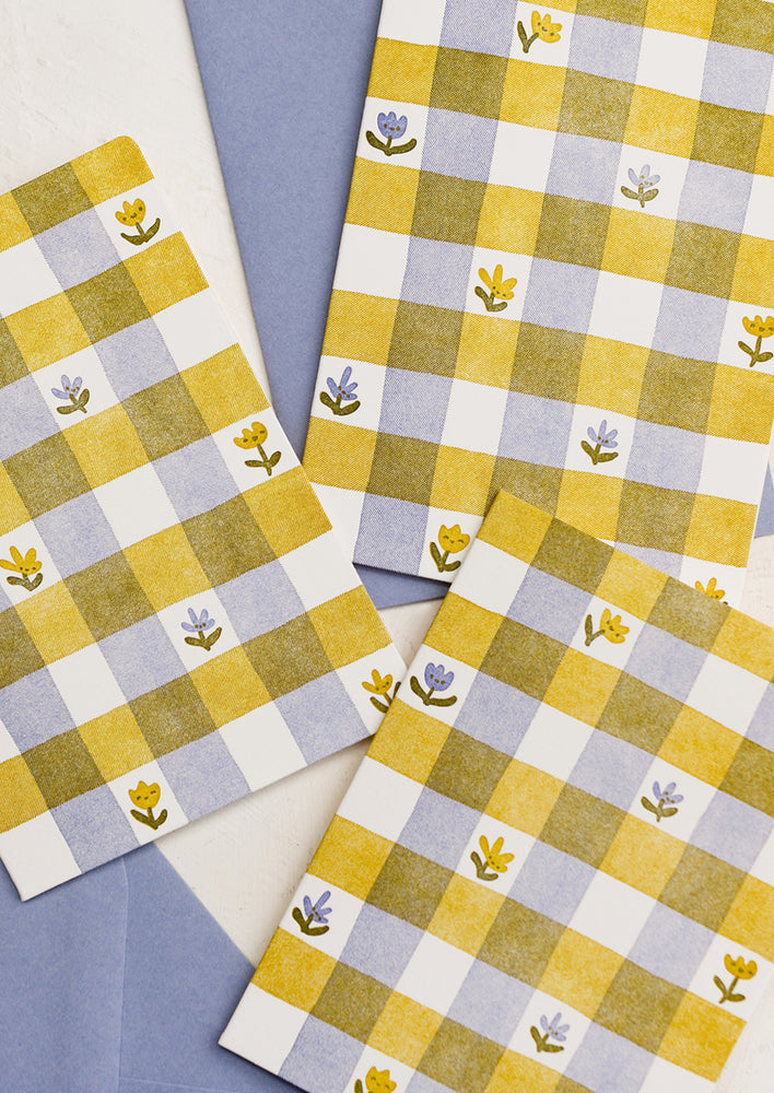 A letterpress printed card set in yellow and lavender floral print gingham.