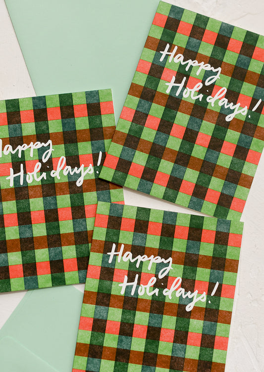 A set of red and green gingham patterned cards, text reads "Happy Holidays!".