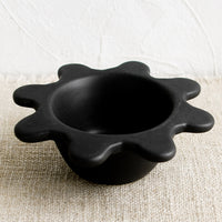 1: A small black ceramic bowl with splatter squiggle shape rim.