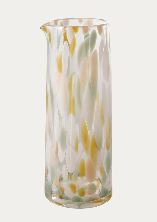 Tall glass vase with wavy multicolor pattern on a white background