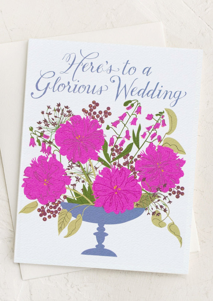 1: A card with pink bouquet reading "Here's to a glorious wedding".