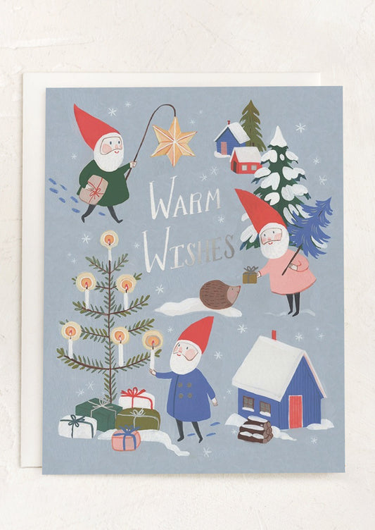 A blue card with illustration of gnomes doing Christmas activities, text reads Warm Wishes.