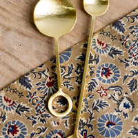 1: Gold finish metal spoons with circular loop at end of handle.