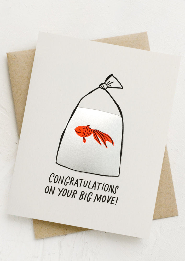 A greeting card with image of goldfish in a bag reading "Congratulations on your new home!".
