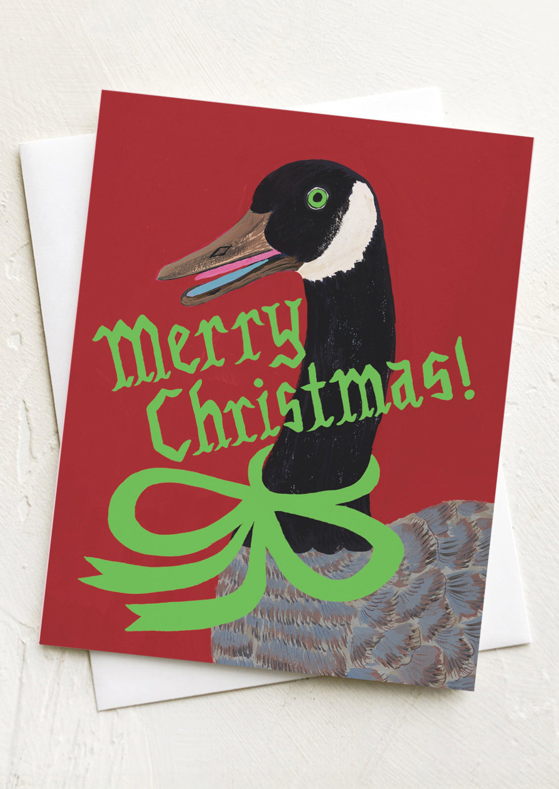 Christmas card with a duck illustration and 'Merry Christmas!' text on a red background.