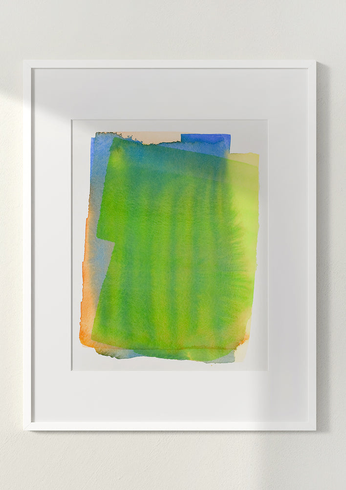 Art print of a watercolor abstract form in green, yellow, blue and orange, in white frame.