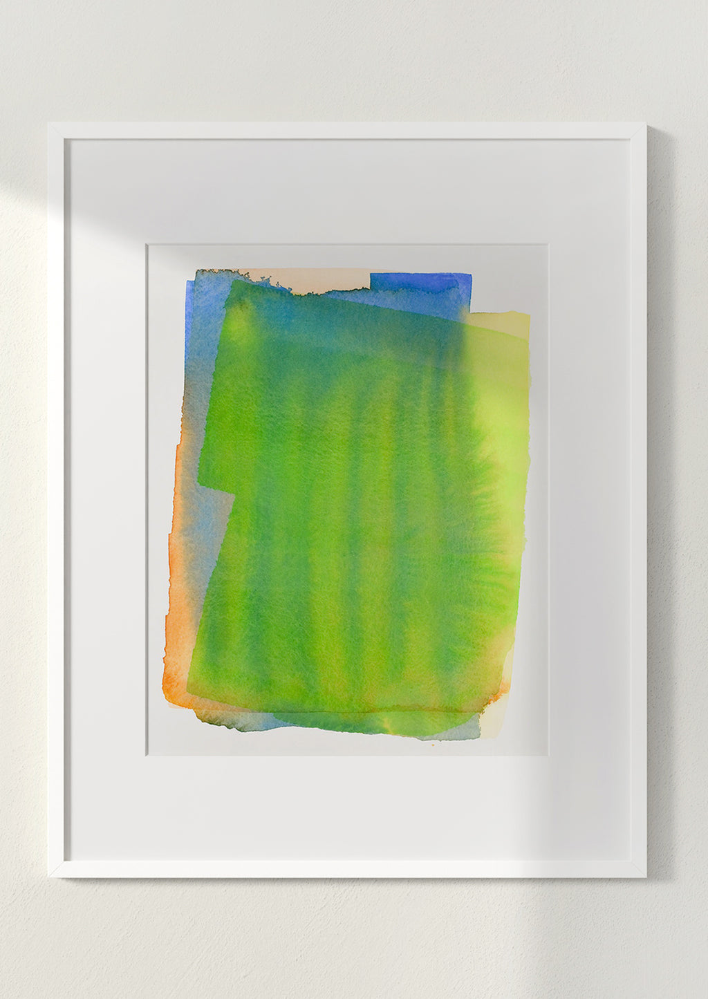 2: Art print of a watercolor abstract form in green, yellow, blue and orange, in white frame.