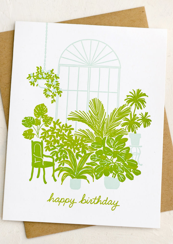 A letterpressed card with image of greenhouse and plants, text reads "Happy birthday".