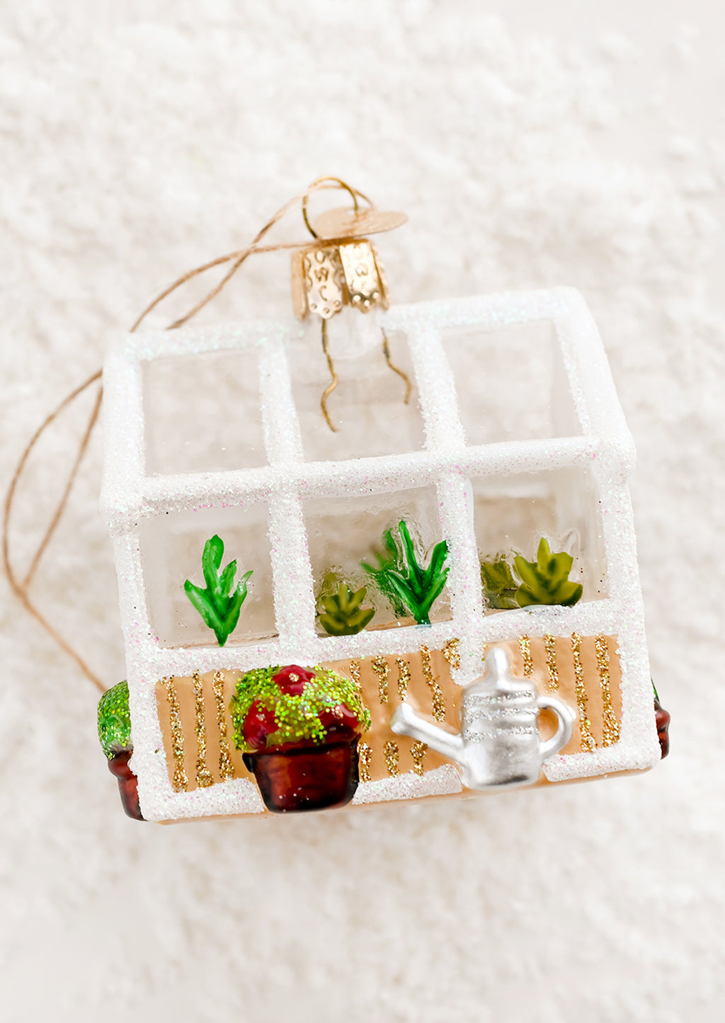 1: A decorative glass holiday ornament of a glass greenhouse.