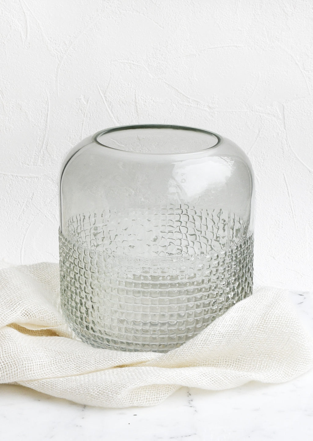 Wide: A glass vase with pyramid grid texture on lower half.