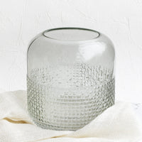 2: A glass vase with pyramid grid texture on lower half.