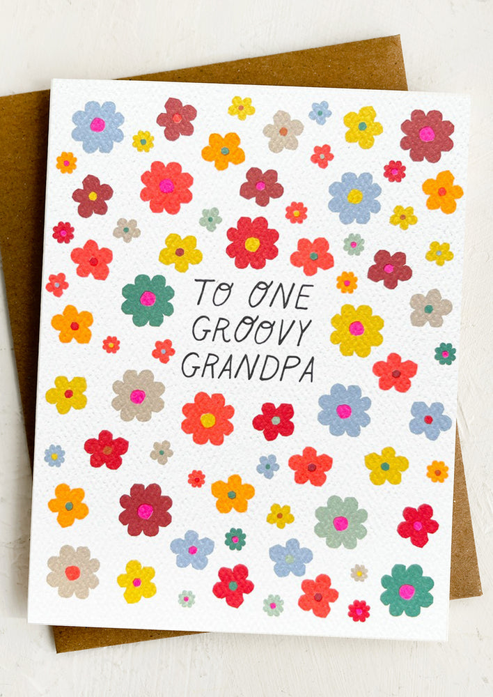 A colorful flower print card reading "To one groovy grandpa".