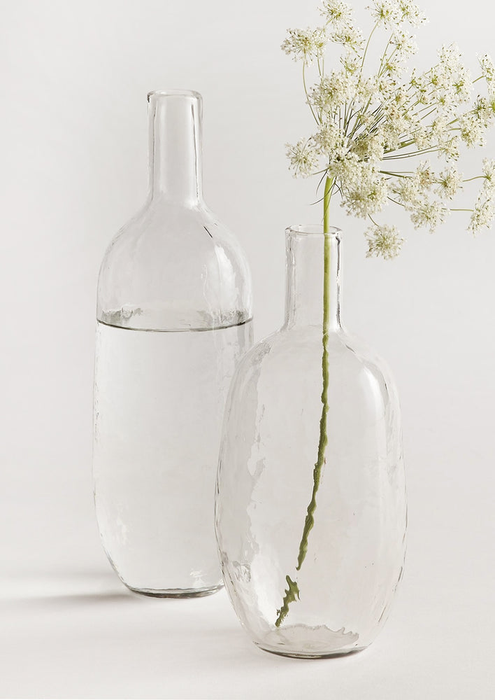 Hammered glass bottles used as vases.
